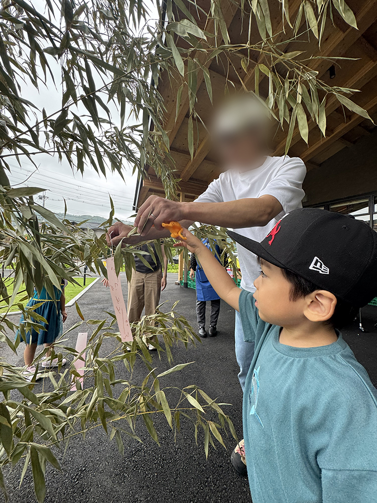一生懸命ペンを持つ子供を見守るパパとママ
